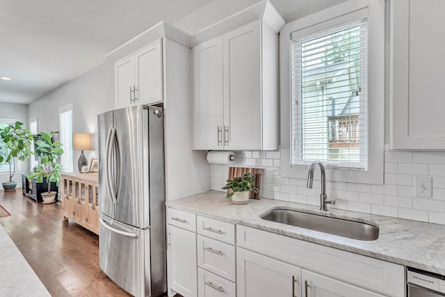 2806 Marlin Ave, Nashville, TN 37215 - kitchen featuring freestanding refrigerator, white cabinetry, decorative backsplash, wood finished floors, and light stone countertops