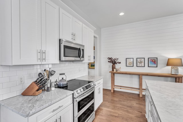 2806 Marlin Ave, Nashville, TN 37215 - kitchen featuring stainless steel appliances, tasteful backsplash, white cabinetry, light wood-type flooring, and recessed lighting