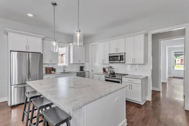 2806 Marlin Ave, Nashville, TN 37215 - kitchen with stainless steel appliances, decorative backsplash, white cabinets, a center island, and recessed lighting