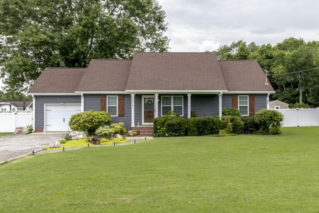7415 Antietam Ln, Murfreesboro, TN 37130 - view of front of house with an attached garage, gravel driveway, and roof with shingles