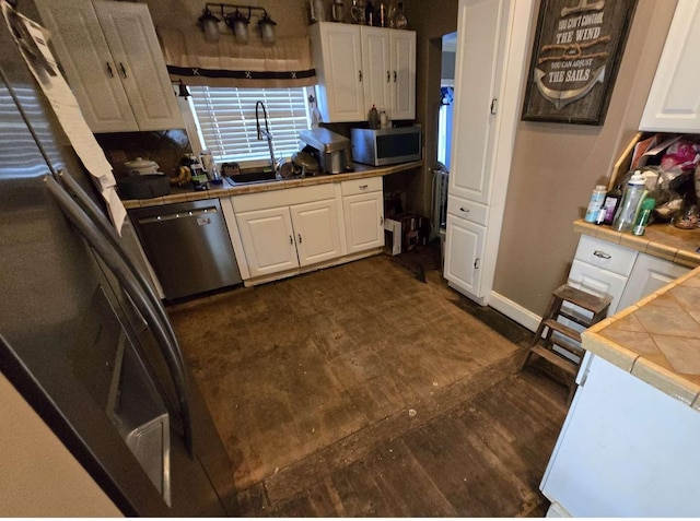 721 Myrtle St, Kingsport, TN 37660 - kitchen with tile countertops, stainless steel appliances, and white cabinetry