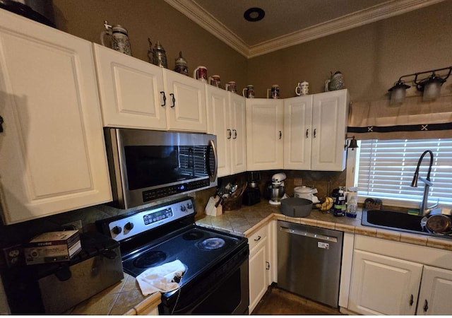 721 Myrtle St, Kingsport, TN 37660 - kitchen with stainless steel appliances, ornamental molding, decorative backsplash, white cabinets, and tile countertops