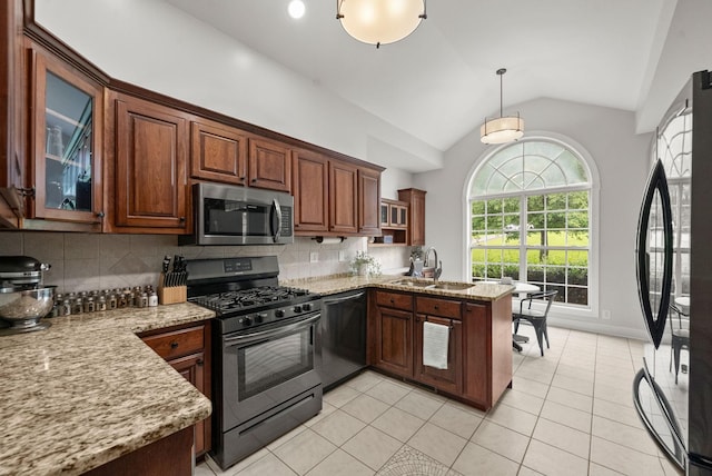 2386 Pleasant View Rd, Pleasant View, TN 37146 - kitchen with appliances with stainless steel finishes, a peninsula, vaulted ceiling, tasteful backsplash, and light tile patterned floors