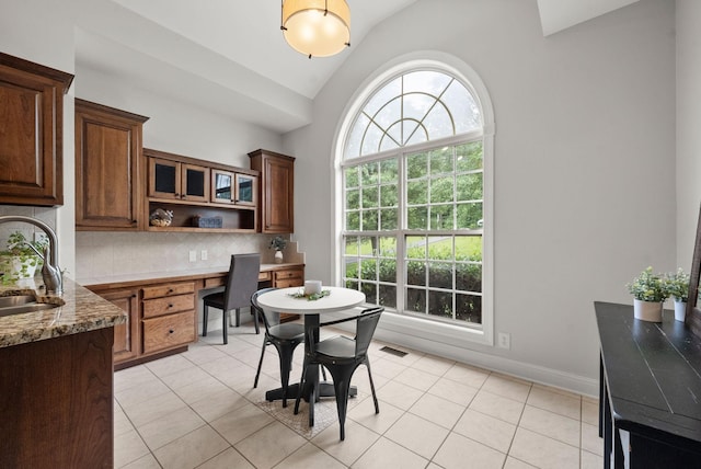 2386 Pleasant View Rd, Pleasant View, TN 37146 - dining area featuring lofted ceiling, built in desk, and light tile patterned floors