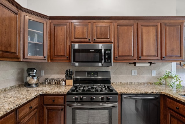 2386 Pleasant View Rd, Pleasant View, TN 37146 - kitchen featuring stainless steel appliances, glass insert cabinets, backsplash, and light stone counters