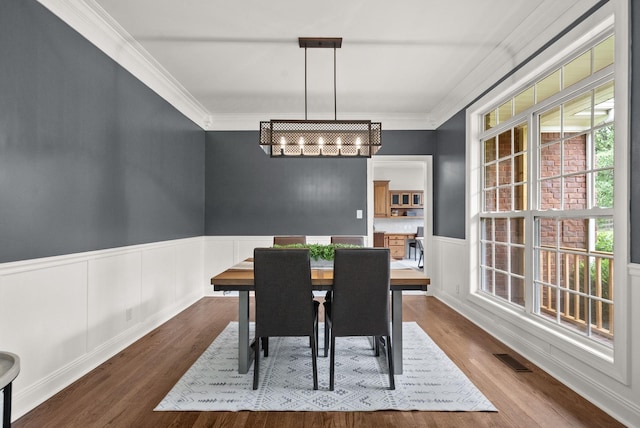2386 Pleasant View Rd, Pleasant View, TN 37146 - dining room featuring healthy amount of natural light, dark wood finished floors, crown molding, and wainscoting