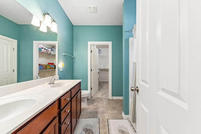 2438 Duxbury Dr, Columbia, TN 38401 - bathroom with double vanity, a walk in closet, and tile patterned flooring