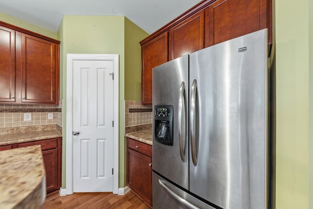 2438 Duxbury Dr, Columbia, TN 38401 - kitchen with stainless steel fridge with ice dispenser, light wood-type flooring, decorative backsplash, and light stone countertops