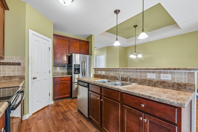 2438 Duxbury Dr, Columbia, TN 38401 - kitchen with appliances with stainless steel finishes, tasteful backsplash, dark wood-style floors, and hanging light fixtures