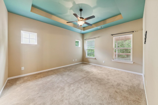 2438 Duxbury Dr, Columbia, TN 38401 - spare room featuring a tray ceiling, carpet flooring, and a ceiling fan