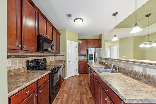 2438 Duxbury Dr, Columbia, TN 38401 - kitchen featuring black appliances, wood finished floors, tasteful backsplash, and hanging light fixtures