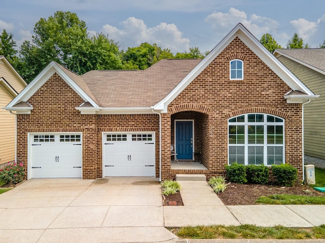 2438 Duxbury Dr, Columbia, TN 38401 - view of front of house with brick siding, a shingled roof, concrete driveway, and a garage
