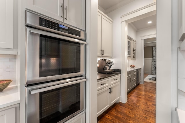 1727 Hillmont Dr, Nashville, TN 37215 - kitchen with double oven, ornamental molding, dark wood-type flooring, tasteful backsplash, and recessed lighting