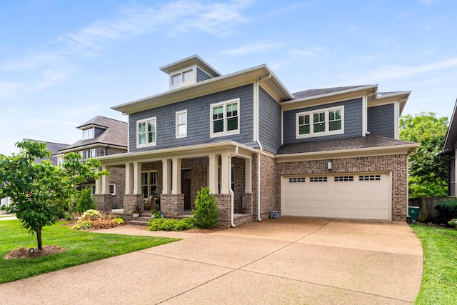 1727 Hillmont Dr, Nashville, TN 37215 - view of front of home with driveway, brick siding, an attached garage, and covered porch