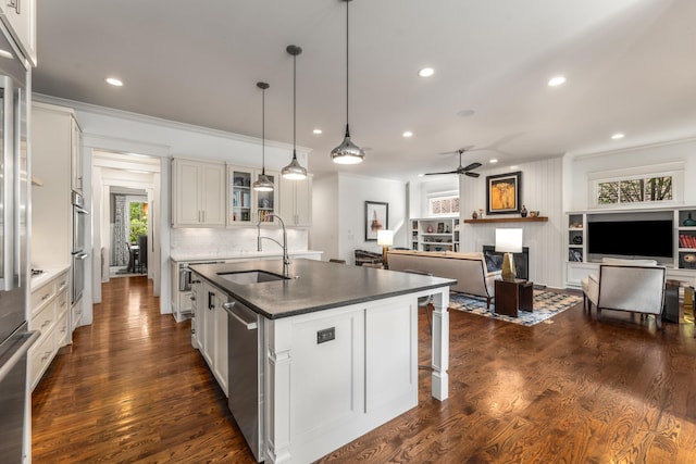 1727 Hillmont Dr, Nashville, TN 37215 - kitchen with crown molding, appliances with stainless steel finishes, glass insert cabinets, an island with sink, and recessed lighting