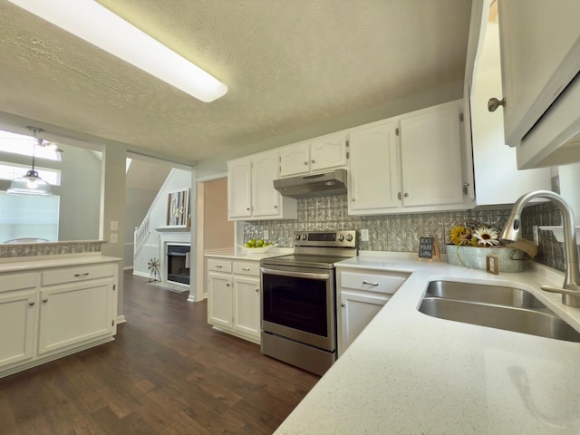 213 Ramsey Rd, Murfreesboro, TN 37127 - kitchen with stainless steel electric stove, under cabinet range hood, a textured ceiling, white cabinets, and backsplash