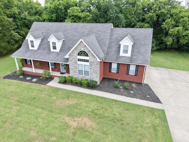 213 Ramsey Rd, Murfreesboro, TN 37127 - cape cod home featuring covered porch, a shingled roof, a front lawn, and stone siding