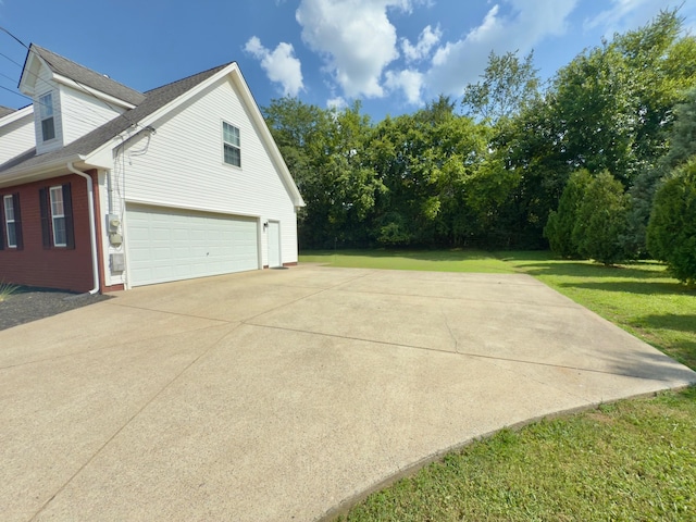 213 Ramsey Rd, Murfreesboro, TN 37127 - view of home's exterior with an attached garage, driveway, a lawn, roof with shingles, and brick siding