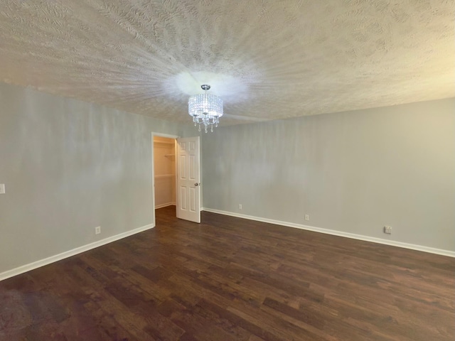 213 Ramsey Rd, Murfreesboro, TN 37127 - empty room with dark wood finished floors, a chandelier, and a textured ceiling