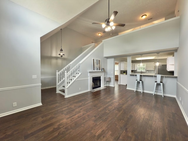213 Ramsey Rd, Murfreesboro, TN 37127 - unfurnished living room with dark wood finished floors, stairway, a ceiling fan, lofted ceiling, and a fireplace