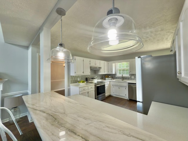 213 Ramsey Rd, Murfreesboro, TN 37127 - kitchen featuring appliances with stainless steel finishes, dark wood-style floors, light countertops, decorative backsplash, and a textured ceiling