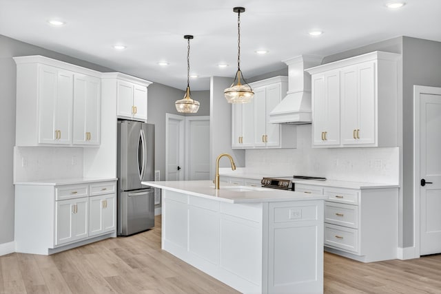 1263 N Sumner Rd, Bethpage, TN 37022 - kitchen with appliances with stainless steel finishes, custom range hood, light countertops, backsplash, and light wood-type flooring