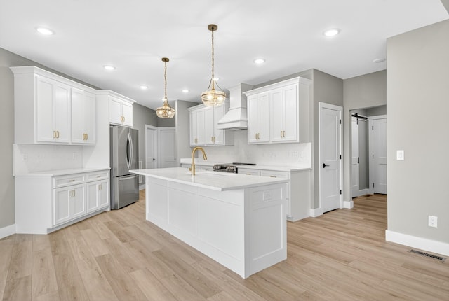 1263 N Sumner Rd, Bethpage, TN 37022 - kitchen featuring stainless steel appliances, custom exhaust hood, tasteful backsplash, light countertops, and light wood finished floors
