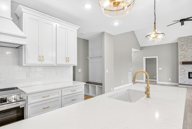1263 N Sumner Rd, Bethpage, TN 37022 - kitchen with electric stove, custom exhaust hood, open floor plan, decorative light fixtures, and white cabinetry