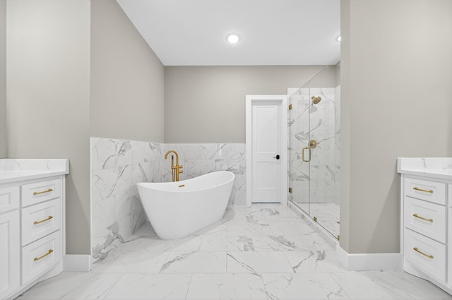1263 N Sumner Rd, Bethpage, TN 37022 - full bath featuring vanity, marble look tiles, a marble finish shower, a freestanding bath, and a wainscoted wall