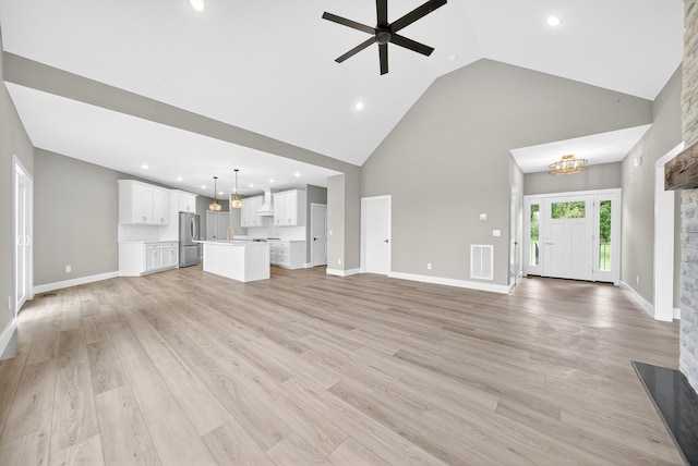 1263 N Sumner Rd, Bethpage, TN 37022 - unfurnished living room featuring high vaulted ceiling, ceiling fan, recessed lighting, a chandelier, and light wood-type flooring