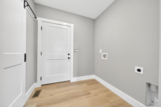 1263 N Sumner Rd, Bethpage, TN 37022 - washroom featuring hookup for an electric dryer, washer hookup, light wood-type flooring, and a barn door