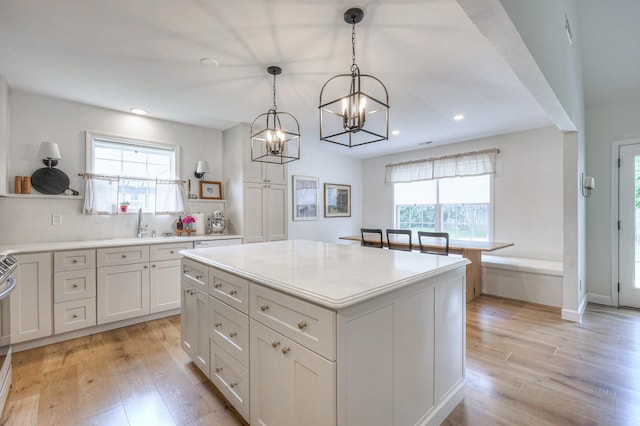2808 Lafayette Dr, Thompsons Station, TN 37179 - kitchen with a chandelier, light wood finished floors, recessed lighting, light countertops, and white cabinetry