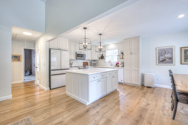 2808 Lafayette Dr, Thompsons Station, TN 37179 - kitchen with stainless steel appliances, white cabinets, light countertops, light wood finished floors, and recessed lighting