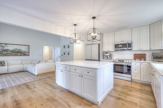 2808 Lafayette Dr, Thompsons Station, TN 37179 - kitchen with stainless steel appliances, light countertops, light wood-type flooring, and open floor plan