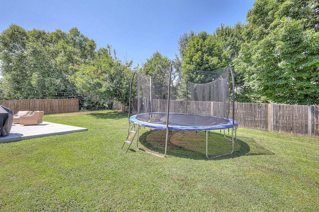 2808 Lafayette Dr, Thompsons Station, TN 37179 - fenced backyard featuring a trampoline and a patio area