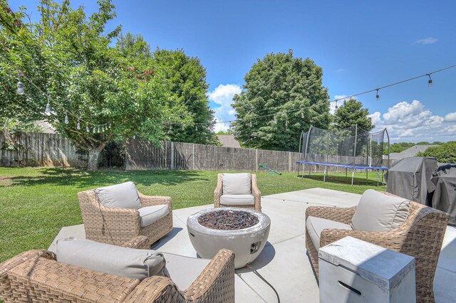 2808 Lafayette Dr, Thompsons Station, TN 37179 - fenced backyard with a trampoline, a patio, and a fire pit