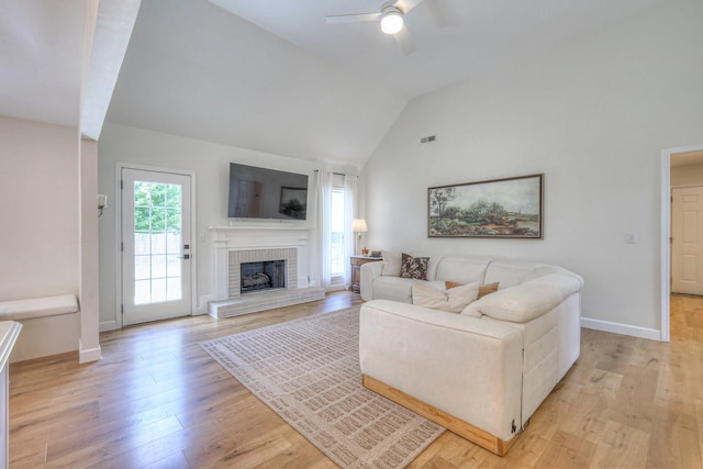 2808 Lafayette Dr, Thompsons Station, TN 37179 - living room featuring a ceiling fan, a brick fireplace, light wood finished floors, and high vaulted ceiling