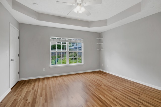 3313 Monoco Dr, Spring Hill, TN 37174 - empty room featuring light wood-type flooring, a raised ceiling, and a ceiling fan