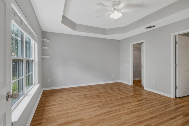 3313 Monoco Dr, Spring Hill, TN 37174 - empty room with a tray ceiling, light wood-type flooring, and ceiling fan