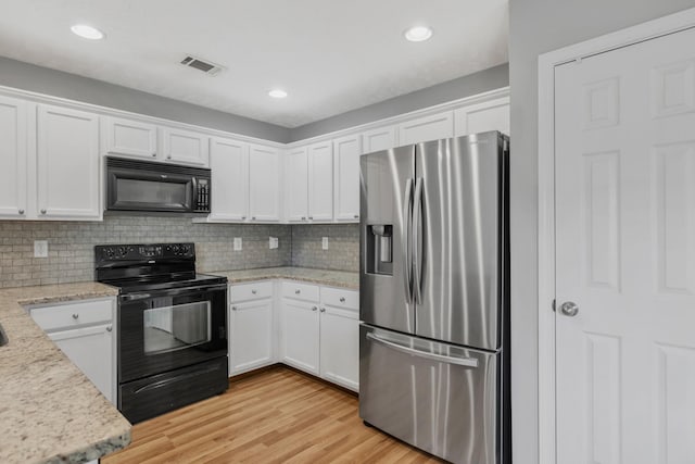 3313 Monoco Dr, Spring Hill, TN 37174 - kitchen with black appliances, white cabinets, tasteful backsplash, light wood-style flooring, and light stone counters