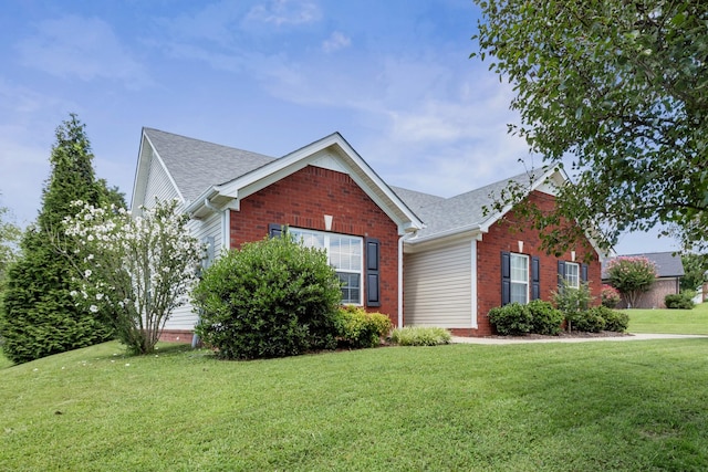 3313 Monoco Dr, Spring Hill, TN 37174 - view of front of home with a front yard, brick siding, and roof with shingles
