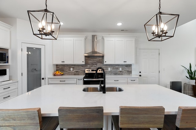 1020 Loggins Rd, Charlotte, TN 37036 - kitchen featuring a chandelier, wall chimney exhaust hood, range with electric stovetop, tasteful backsplash, and recessed lighting