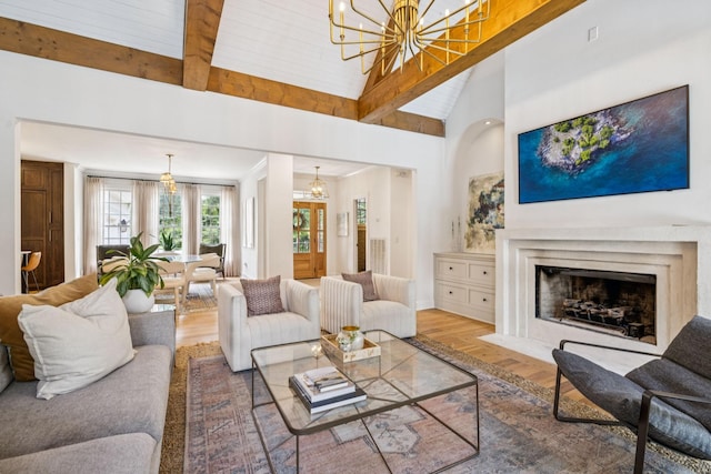 3404 Benham Ave, Nashville, TN 37215 - living room featuring a chandelier, wood finished floors, a fireplace with flush hearth, high vaulted ceiling, and beamed ceiling