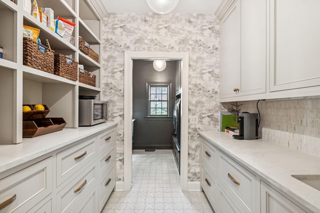 3404 Benham Ave, Nashville, TN 37215 - kitchen featuring open shelves, stainless steel microwave, light countertops, tasteful backsplash, and white cabinets