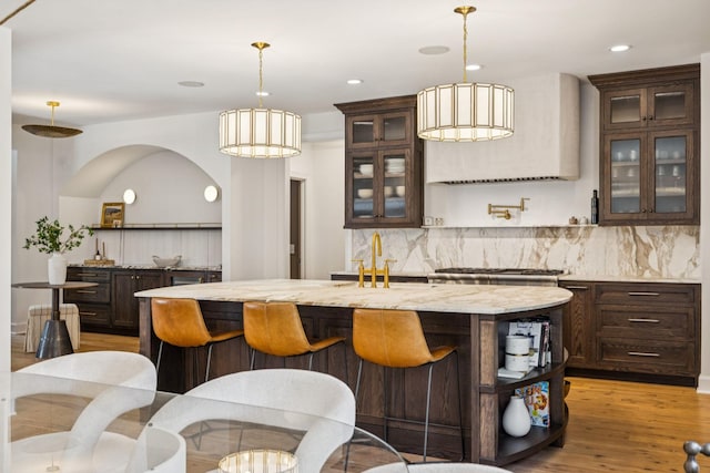 3404 Benham Ave, Nashville, TN 37215 - bar area featuring decorative backsplash, light wood-style flooring, hanging light fixtures, and recessed lighting