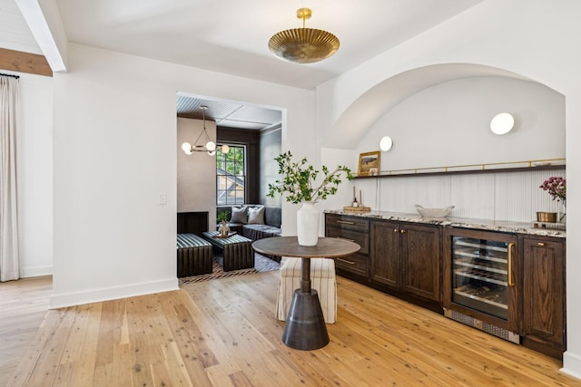 3404 Benham Ave, Nashville, TN 37215 - indoor bar featuring beverage cooler, light wood-type flooring, hanging light fixtures, and a chandelier