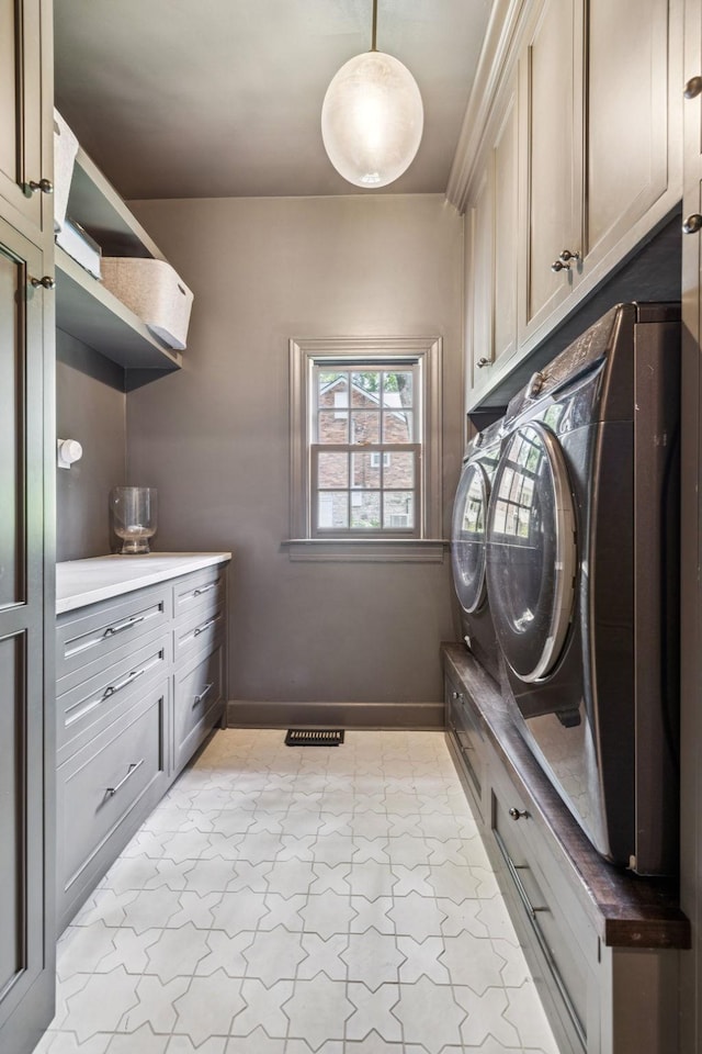 3404 Benham Ave, Nashville, TN 37215 - laundry area featuring cabinet space, washing machine and dryer, and light marble finish flooring