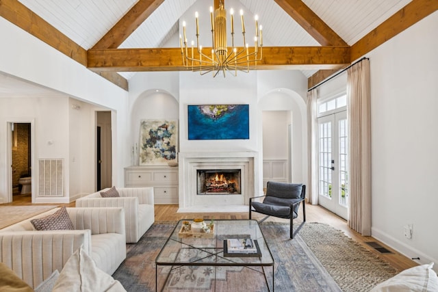 3404 Benham Ave, Nashville, TN 37215 - living room featuring a wood ceiling with exposed beams, french doors, a chandelier, high vaulted ceiling, and a warm lit fireplace