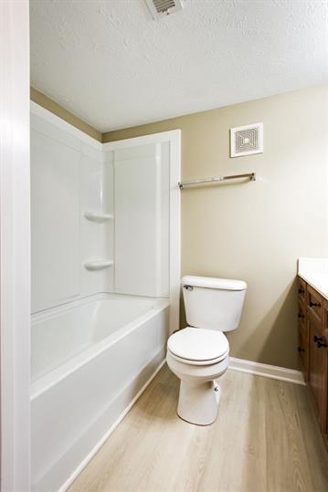 420 Elysian Fields Rd Unit E4, Nashville, TN 37211 - full bath featuring vanity, wood finished floors, a textured ceiling, and shower / tub combination