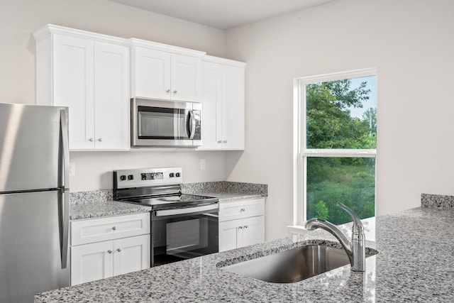 2008 Lala Loop, White Bluff, TN 37187 - kitchen featuring appliances with stainless steel finishes, light stone countertops, and white cabinetry
